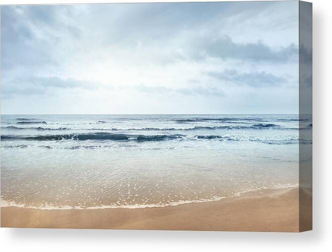 Water's Edge Canvas Print featuring the photograph View of beach and clouds by FangXiaNuo