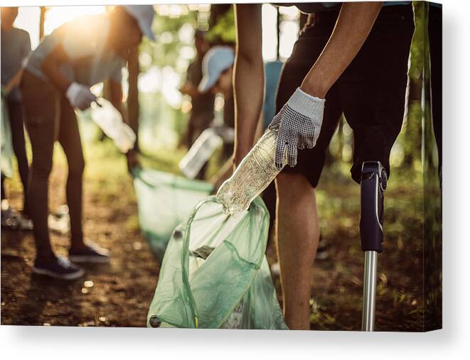 Working Canvas Print featuring the photograph Volunteers cleaning park by South_agency