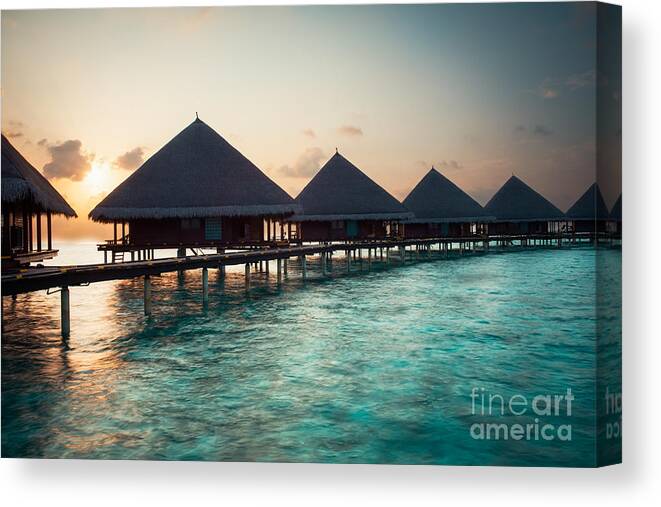 Amazing Canvas Print featuring the photograph Waterbungalows At Sunset by Hannes Cmarits