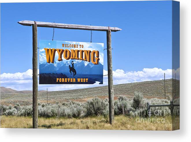 Welcome Canvas Print featuring the photograph Welcome To Wyoming Sign by Bill Bachmann