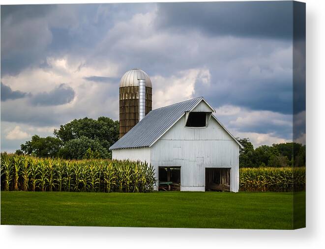 Art Canvas Print featuring the photograph White Barn and Silo with Storm Clouds by Ron Pate