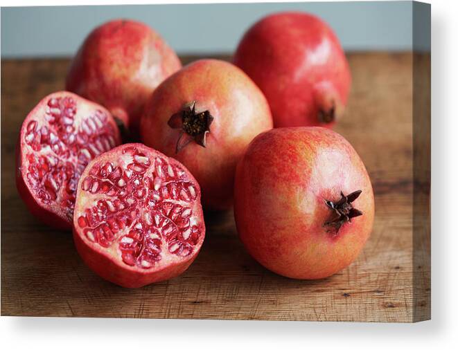 Cutting Board Canvas Print featuring the photograph Whole And Halved Pomegranates by Danielle Wood