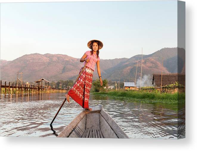 People Canvas Print featuring the photograph Woman Rowing Boat Through Floating by Martin Puddy