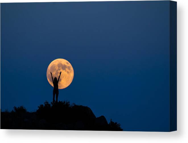On Top Of The World Canvas Print featuring the photograph Woman silhouette on the full moon by Manuel Breva Colmeiro