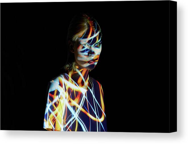 People Canvas Print featuring the photograph Young Woman Covered In Colorful Lights by Mads Perch