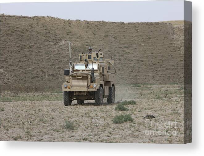 Mrap Canvas Print featuring the photograph A U.s. Army Cougar Patrols A Wadi by Terry Moore