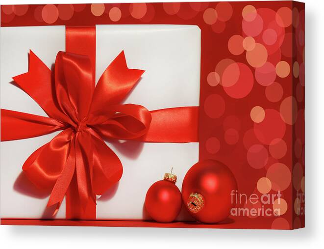 Background Canvas Print featuring the photograph Big red bow on gift by Sandra Cunningham