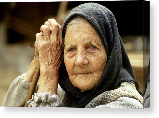 Romania Canvas Print featuring the photograph Old woman in Vrancea Romania by Emanuel Tanjala