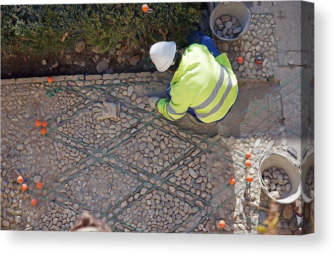 Granada Canvas Print featuring the photograph Repairing a cobbled pavement by Rod Jones