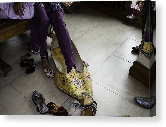 Amritsar Canvas Print featuring the photograph Trying on a very large decorated shoe by Ashish Agarwal