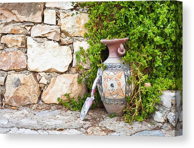 Background Canvas Print featuring the photograph Vase and trowel by Tom Gowanlock