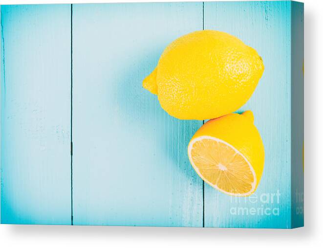 Fruits Canvas Print featuring the photograph Fresh Yellow Lemons On Wooden Table #1 by Radu Bercan