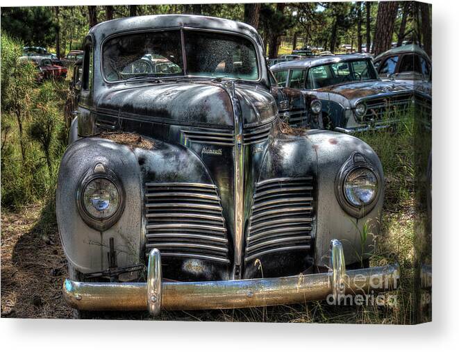 Rusty Cars Canvas Print featuring the photograph 1940 Plymouth by John Strong