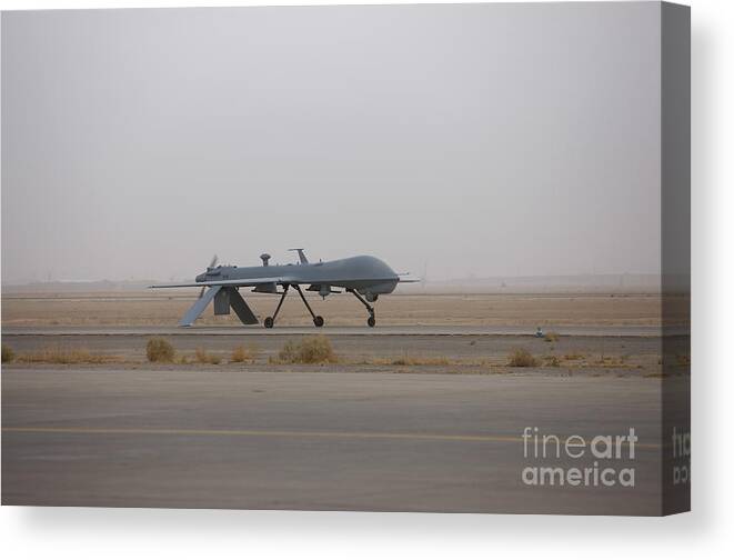 Aviation Canvas Print featuring the photograph A Mq-1c Warrior Taxis Out To The Runway by Terry Moore