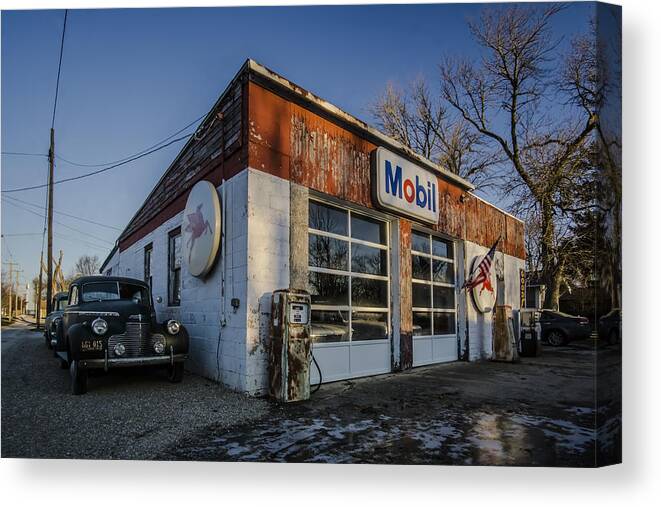 Vintage Cars Canvas Print featuring the photograph A vintage gas station and vintage cars in early morning light by Sven Brogren