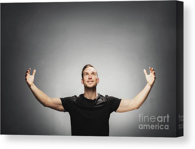 Man Canvas Print featuring the photograph Attractive man smiling, spreading his arms. by Michal Bednarek