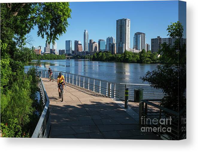 Boardwalk Canvas Print featuring the photograph Bikers race the Boardwalk Trail at Lady Bird Lake in downtown Austin, one of the best urban trails in America by Dan Herron