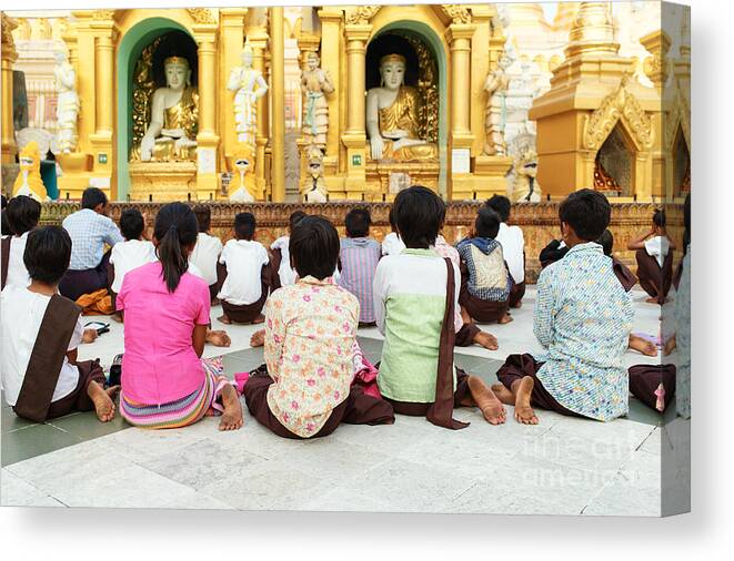 Buddha Canvas Print featuring the photograph Children Pray at Shwedagon Pagoda by Dean Harte