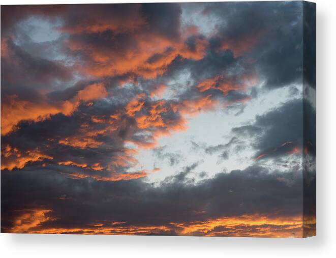Stormy Clouds Canvas Print featuring the photograph Dramatic sunset sky with orange cloud colors by Michalakis Ppalis