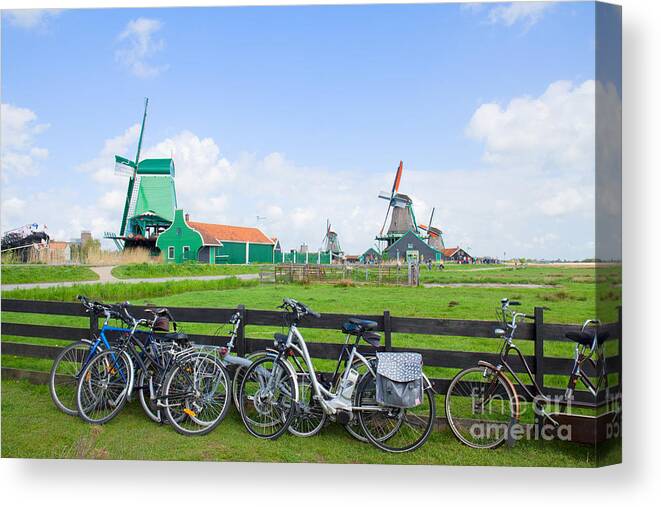 Netherlands Canvas Print featuring the photograph dutch windmills with bikes in Zaanse Schans by Anastasy Yarmolovich
