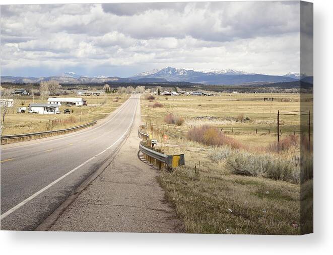 Highway; Distance; Horizon; Future; Village; Lonesome; Far Mountains; Perspective; Vista; Range; Scope; New Mexico Canvas Print featuring the photograph Far Horizon by Tom Cochran
