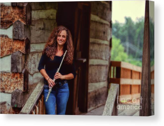 Nina Assimakopoulos Canvas Print featuring the photograph Female flute player at log cabin by Dan Friend