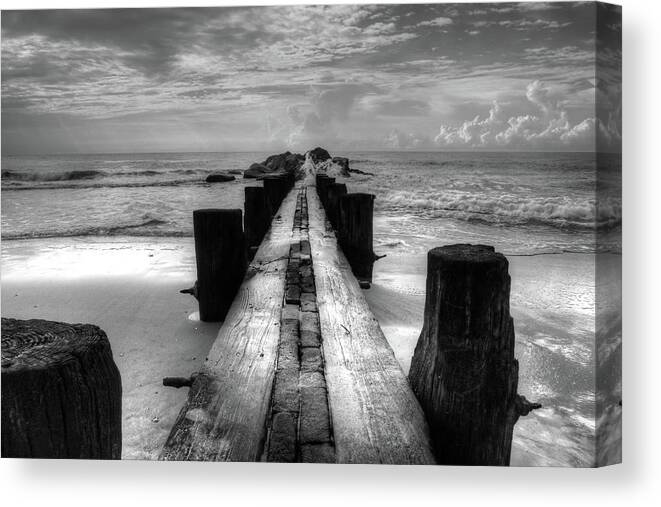 Folly Beach Pilings Canvas Print featuring the photograph Folly Beach Pilings Charleston South Carolina In Black and White by Carol Montoya