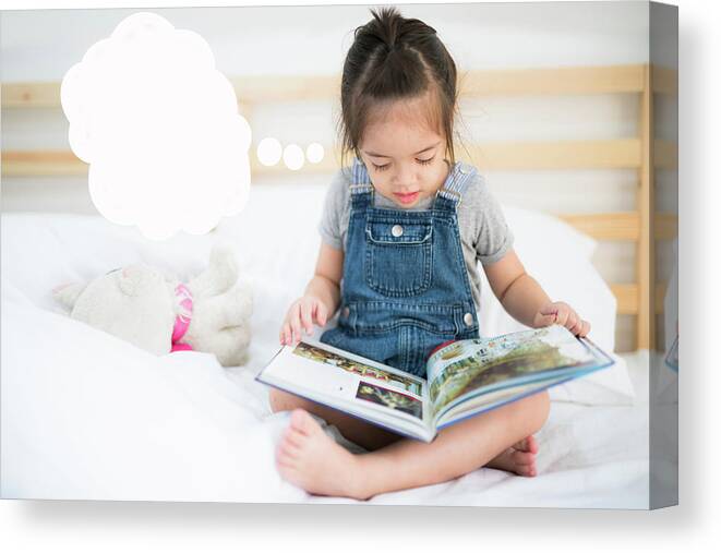 Reading Canvas Print featuring the photograph Girl read a book by Anek Suwannaphoom