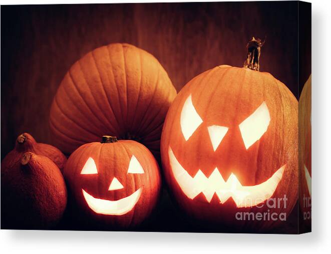 Halloween Canvas Print featuring the photograph Halloween pumpkins glowing, jack-o-lantern by Michal Bednarek