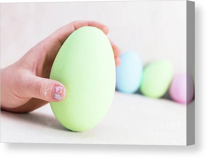 Easter Canvas Print featuring the photograph Hand holding one Easter Egg. by Michal Bednarek
