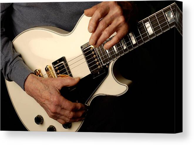 Les Paul Canvas Print featuring the photograph Les Paul's hands holding his white gibson Les Paul custom guitar by Gene Martin by David Smith