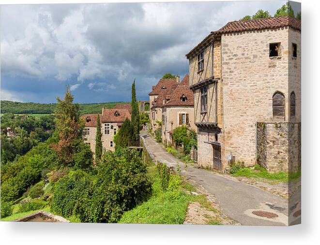 Blue Canvas Print featuring the photograph Main treet in Saint Cirq Lapopie in France by Semmick Photo