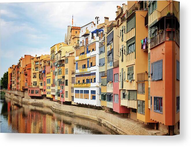 Girona Canvas Print featuring the photograph Picturesque buildings along the river in Girona, Catalonia by GoodMood Art