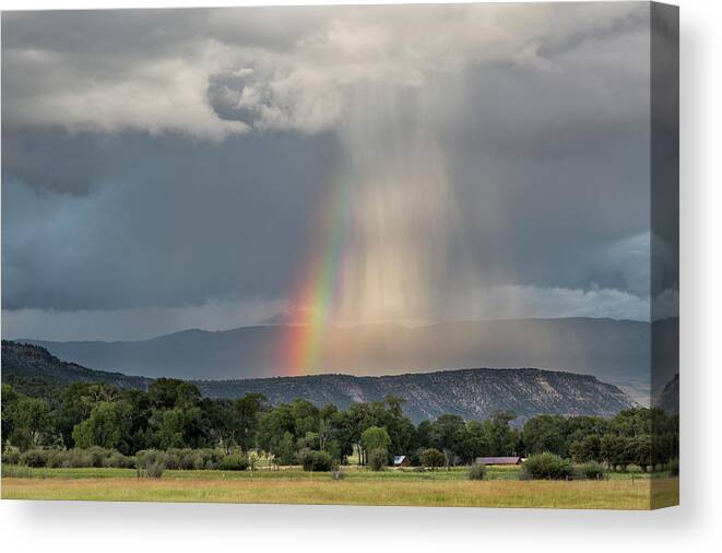 Rainbow Canvas Print featuring the photograph Rainbow Storm Over Log Hill by Denise Bush