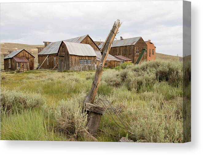 Abandoned Canvas Print featuring the photograph Rustic wooden structures in Bodie, California by Karen Foley