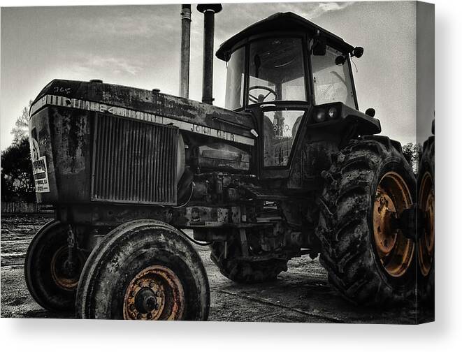 John Deere Tractor Canvas Print featuring the photograph Rusty Yellow-Rimmed Tractor by Eugene Campbell