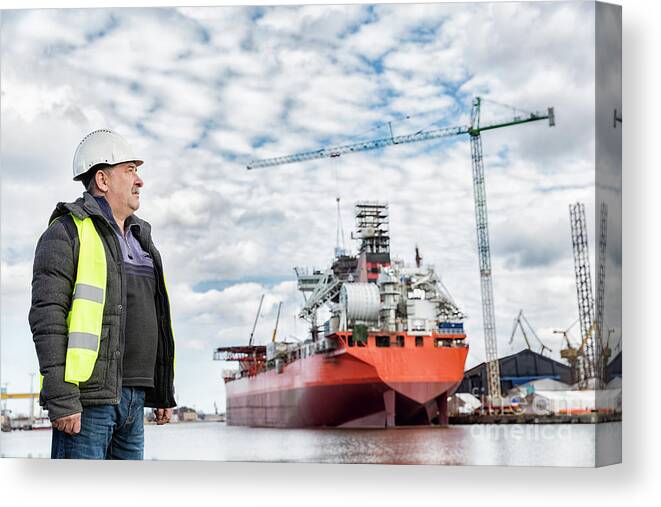 Engineer Canvas Print featuring the photograph Shipbuilding engineer at the dockside in a port. by Michal Bednarek