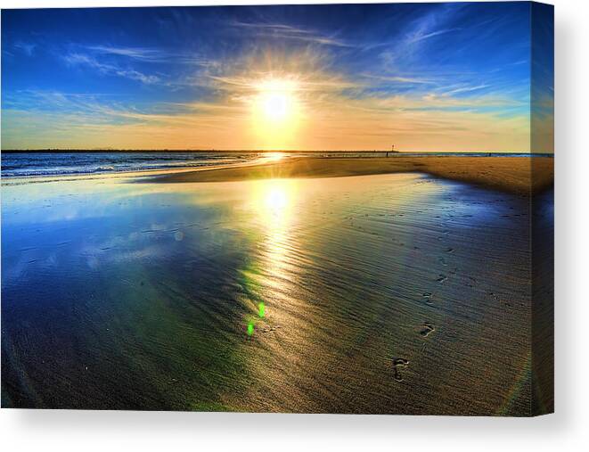 Sand Sea Beach Sun Footprints Sky Canvas Print featuring the photograph Sunset by Wendell Ward