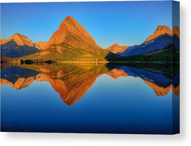 Swiftcurrent Lake Canvas Print featuring the photograph Swiftcurrent Morning Reflections by Greg Norrell