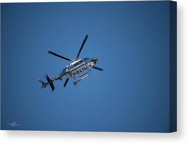 Swedish Police Helicopter Canvas Print featuring the photograph The searcher in the air by Torbjorn Swenelius