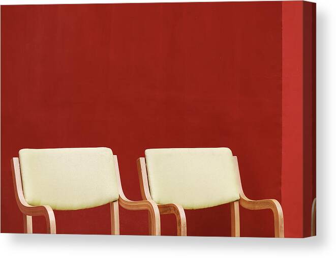 Plain Red Wall Canvas Print featuring the photograph Two Yellow Chairs Minimalism by Prakash Ghai