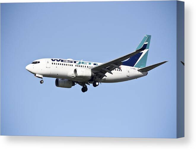 100509 Airplanes Landing In Toronto Canvas Print featuring the photograph WestJet by Nick Mares