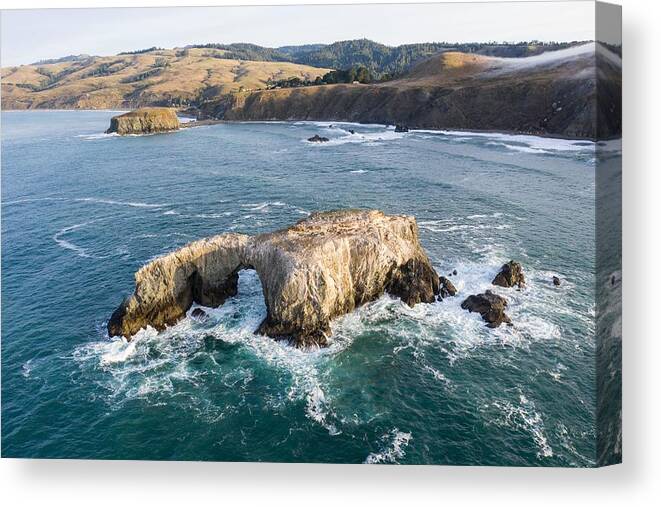 Landscapeaerial Canvas Print featuring the photograph The Pacific Ocean Washes Against A Sea #1 by Ethan Daniels