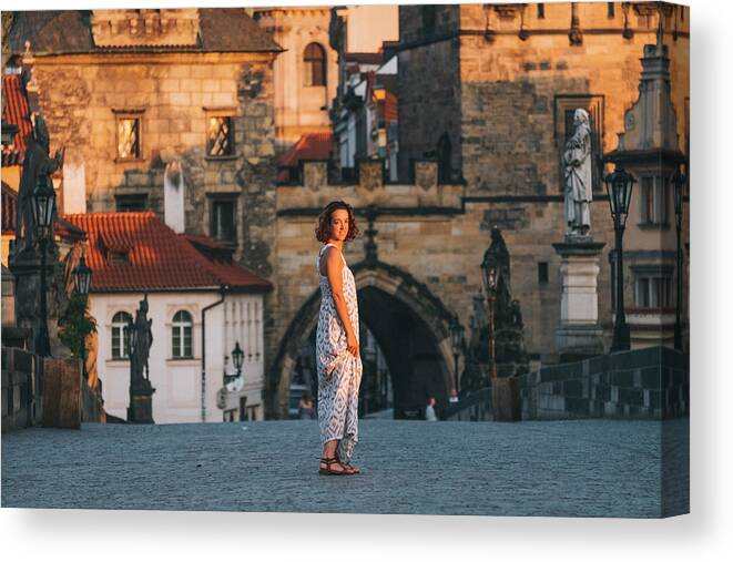 Bridge Canvas Print featuring the photograph Woman Walking Through Charles Bridge, Prague, Czech Republic #1 by Cavan Images