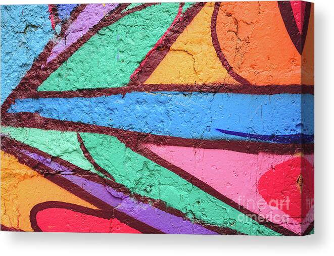 Abandoned Canvas Print featuring the photograph Detail of an anonymous street graffiti with many colors, cheerful urban background. #2 by Joaquin Corbalan