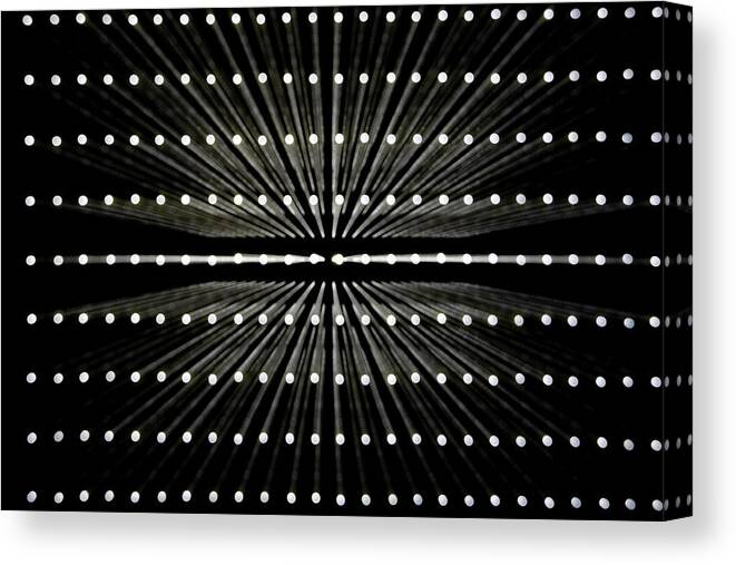 In A Row Canvas Print featuring the photograph A Grid Of White Lights Illuminated by Caspar Benson
