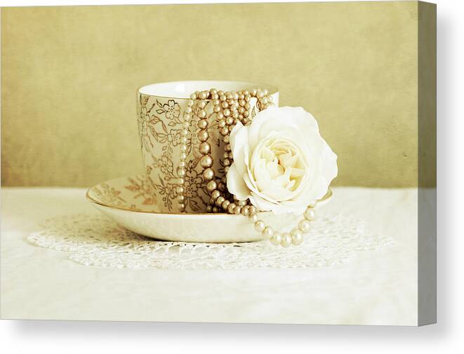 Antique Cup And Saucer With White Flower And Pearls Canvas Print featuring the photograph Antique Cup And Saucer With White Flower And Pearls by Tom Quartermaine