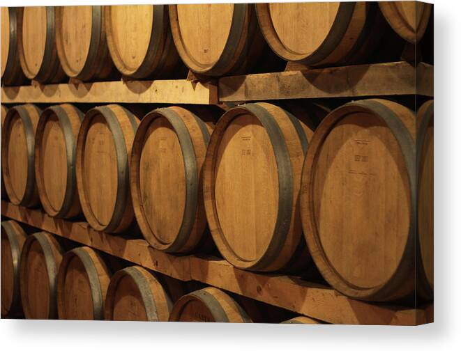 Aging Process Canvas Print featuring the photograph Barrels Of Wine In Cellar by Tom And Steve