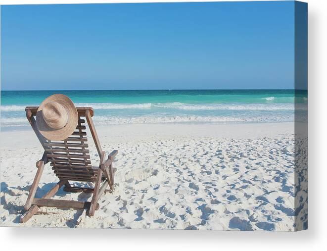 Scenics Canvas Print featuring the photograph Beach Chair With A Hat, On An Empty by Sasha Weleber