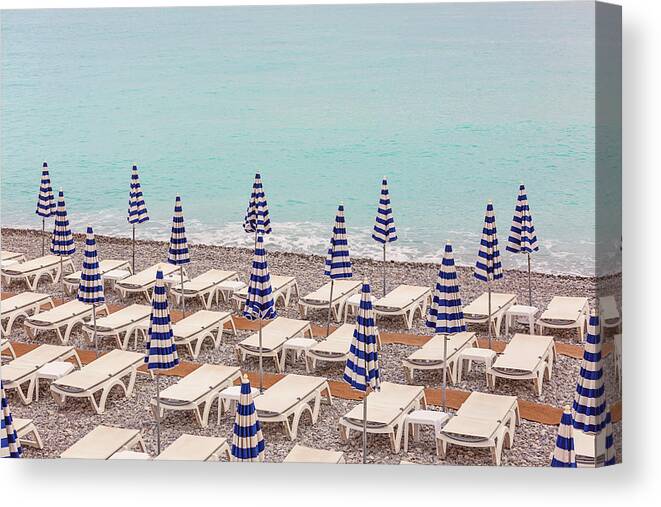 Beach Umbrellas In Nice Canvas Print featuring the photograph Beach Umbrellas in Nice by Melanie Alexandra Price